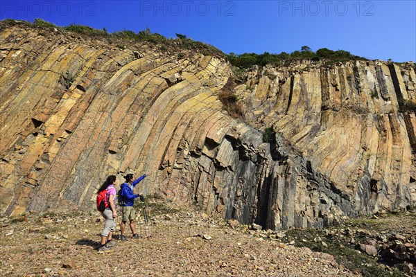 Hikers in front of Hexagonal Rock Columns in Geo Park
