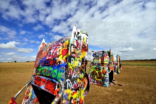 Painted Cadillacs rammed into the ground