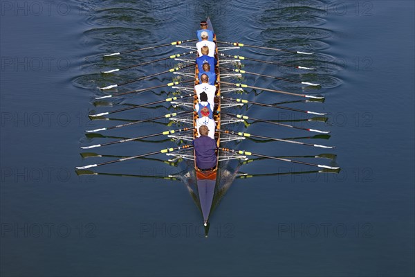 Rowers rowing in rowing boat