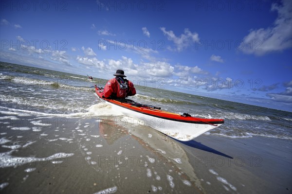 Canoeist in the surf on the beach of Langeoog