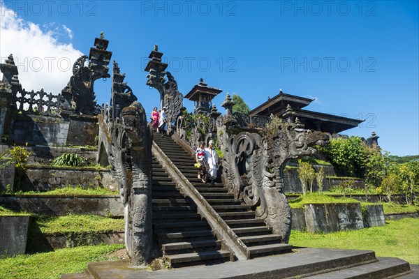 Balinese believers walk down stairs