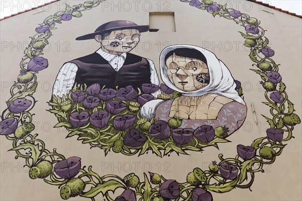 Medieval peasant couple in a wreath of flowers