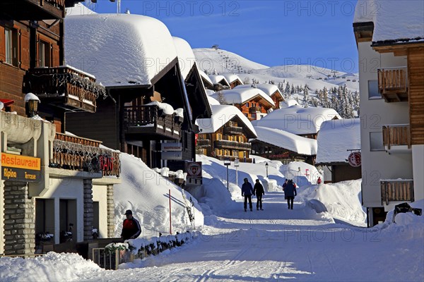Village road with snow-covered chalets