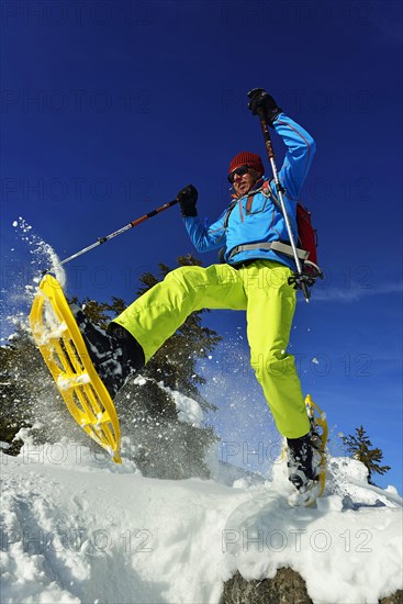 Snowshoe walker with big steps in the snow