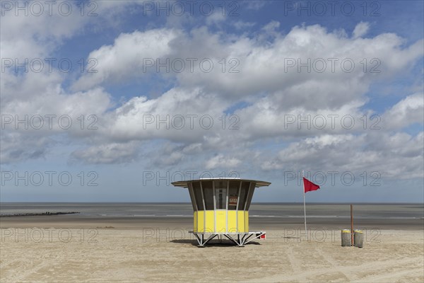 Sandy beach with modern beach guard hut