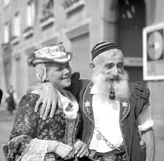 Woman and man dressed in traditional costumes