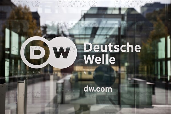 Logo Deutsche Welle at the glass door to the headquarters of the company