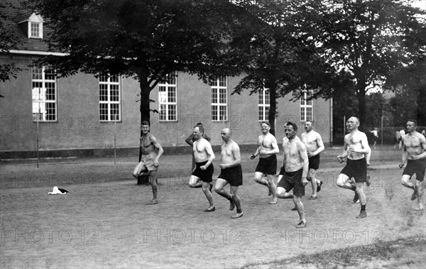 Men jogging with naked torsos