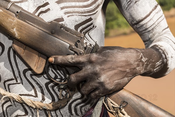Hand of a warrior on rifle