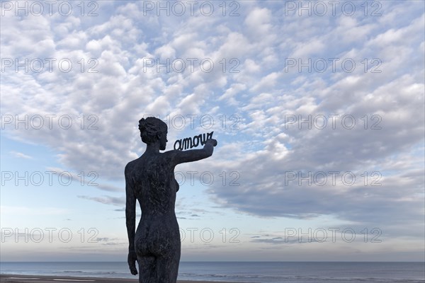 Woman writes French word Amour