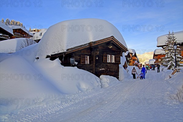 Village road with snow-covered chalets