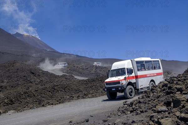 Four-wheel drive vehicles on gravel road to Etna volcano