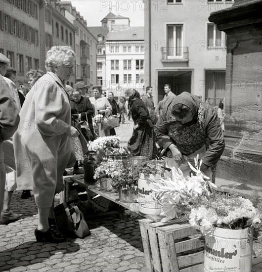 Elderly lady buys a bouquet of flowers