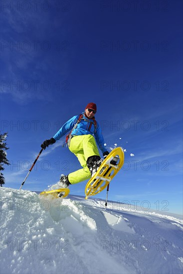Snowshoe walker with big steps in the snow