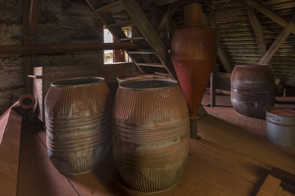 Production room with old barrels covered with bronze dust