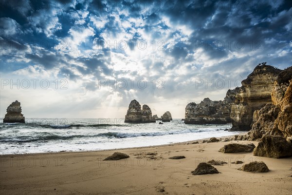 Rocky coast with beach and red rocks
