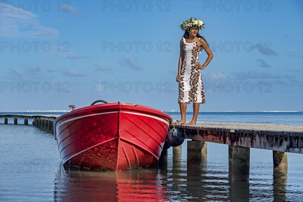 Young woman with flower wreath next to boat