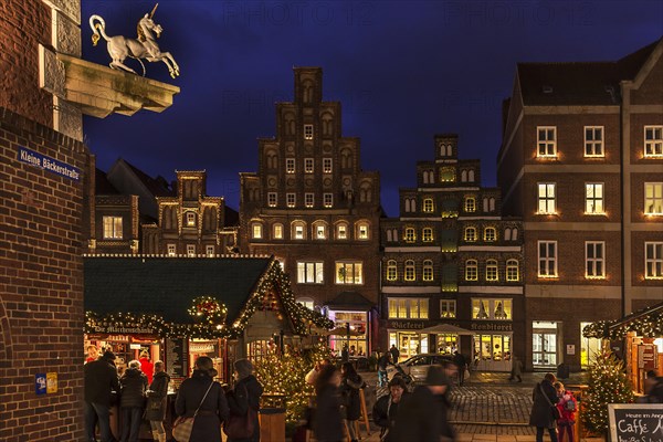 Old gabled houses in Christmas lighting in the evening
