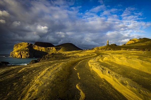 Rocky coast with lighthouse Farol da Ponta dos Capelinhos