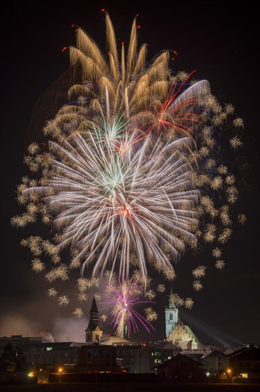 Fireworks over Schwaz on New Year's Eve with hospital church and parish church