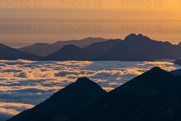 Mountain peak with sea of fog at sunrise