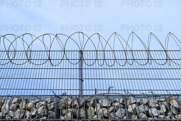 Barbed wire secured stone wall