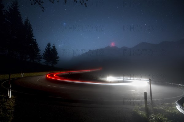 Pass road with cars to Schwagalp with stars and Milky Way