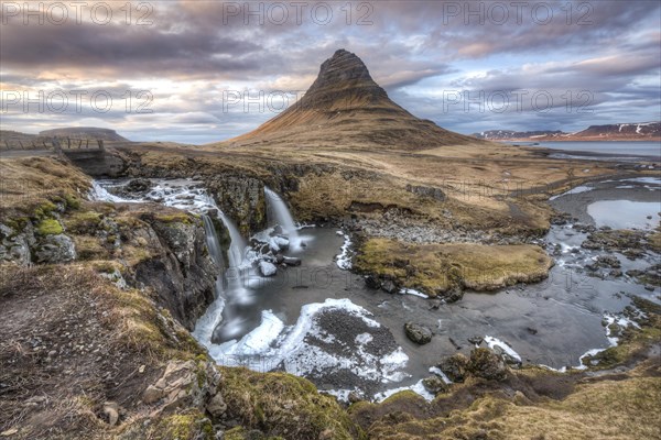 Kirkjufell mountain with Kirkjufellfoss waterfall at sunset