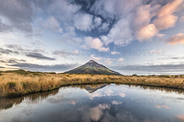 Stratovolcano Mount Taranaki or Mount Egmont reflected in Pouakai Tarn