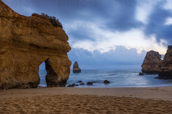 Rocky coast with beach and red rocks