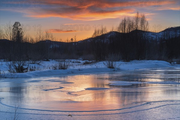 Icy landscape with dramatic sunset