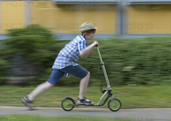 Boy is riding scooter
