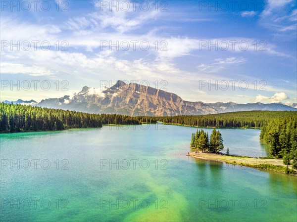 Minnewanka Lake with small peninsula with trees
