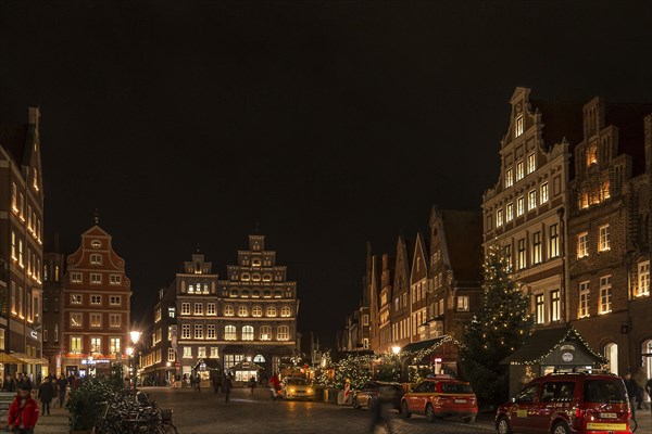 Old gabled houses in Christmas lighting in the evening