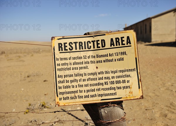 Entrance to the diamond fields Forbidden Shield standing in the sand next to the former diamond city