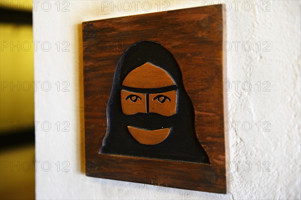 Toilet sign with veiled woman