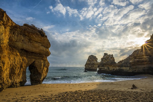 Rocky coast with beach and red rocks
