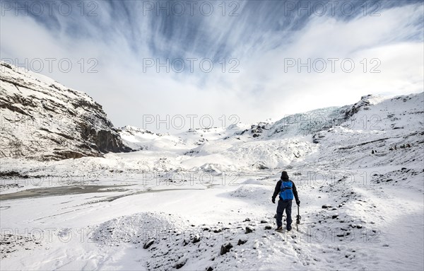 Hiker with ice pick on the glacier