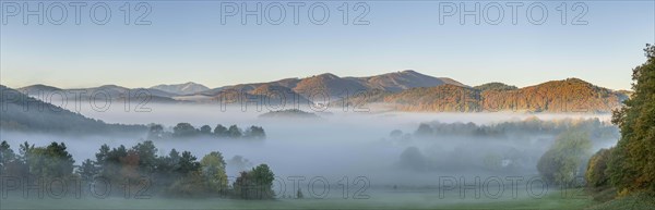 Autumn foggy atmosphere with Schneeberg and pilgrimage church Hafnerberg