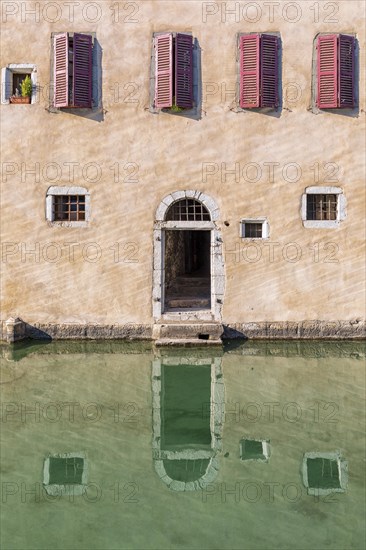 Water reflection of an house at the canal