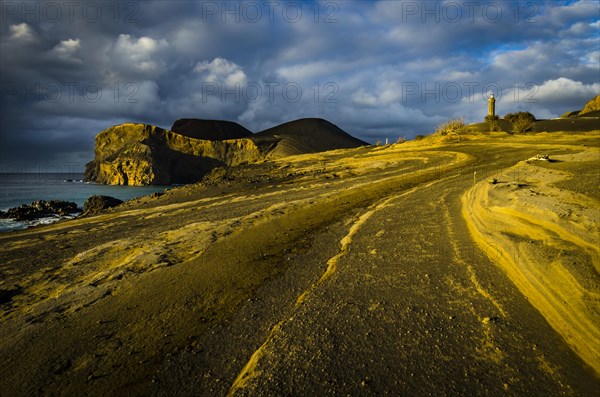 Rocky coast with lighthouse Farol da Ponta dos Capelinhos