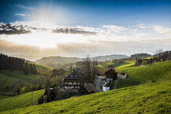 View of hilly landscape with farmhouse