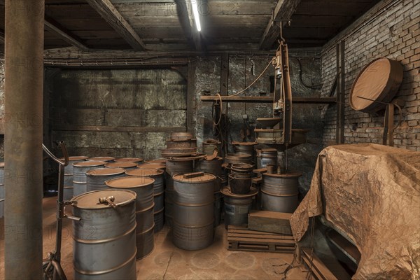 Production room for bronze powder with barrels and machines in a metal powder plant