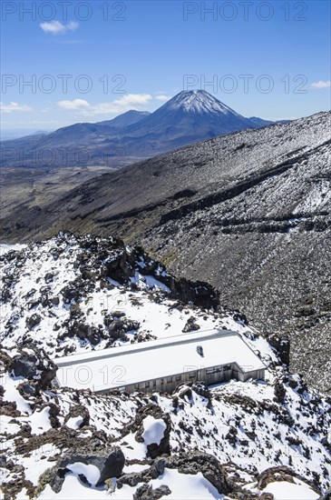 View from Mount Ruapehu on Mount Ngauruhoe with a ski cottage in the foreground
