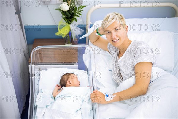 Happy mother enjoying her newborn baby boy still in the hospital