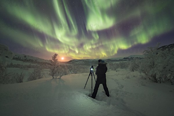 Photographer taking pictures of Northern Lights