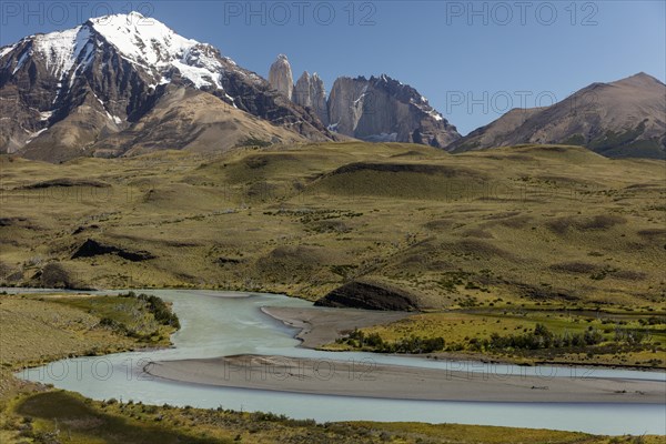 Snow covered peaks of the granite mountains Torres del Paine with the Rio Paine glacial river
