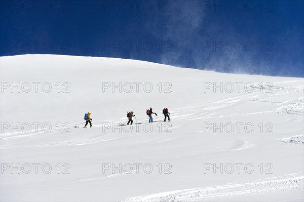 Ski tourers ascending to the summit of Aebeni Fluh
