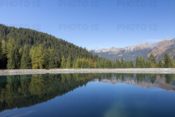 Water reservoir for snow production for the ski slopes on Grubigstein with view to Daniel