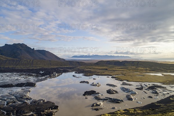 Calving glacier with volcanic massif
